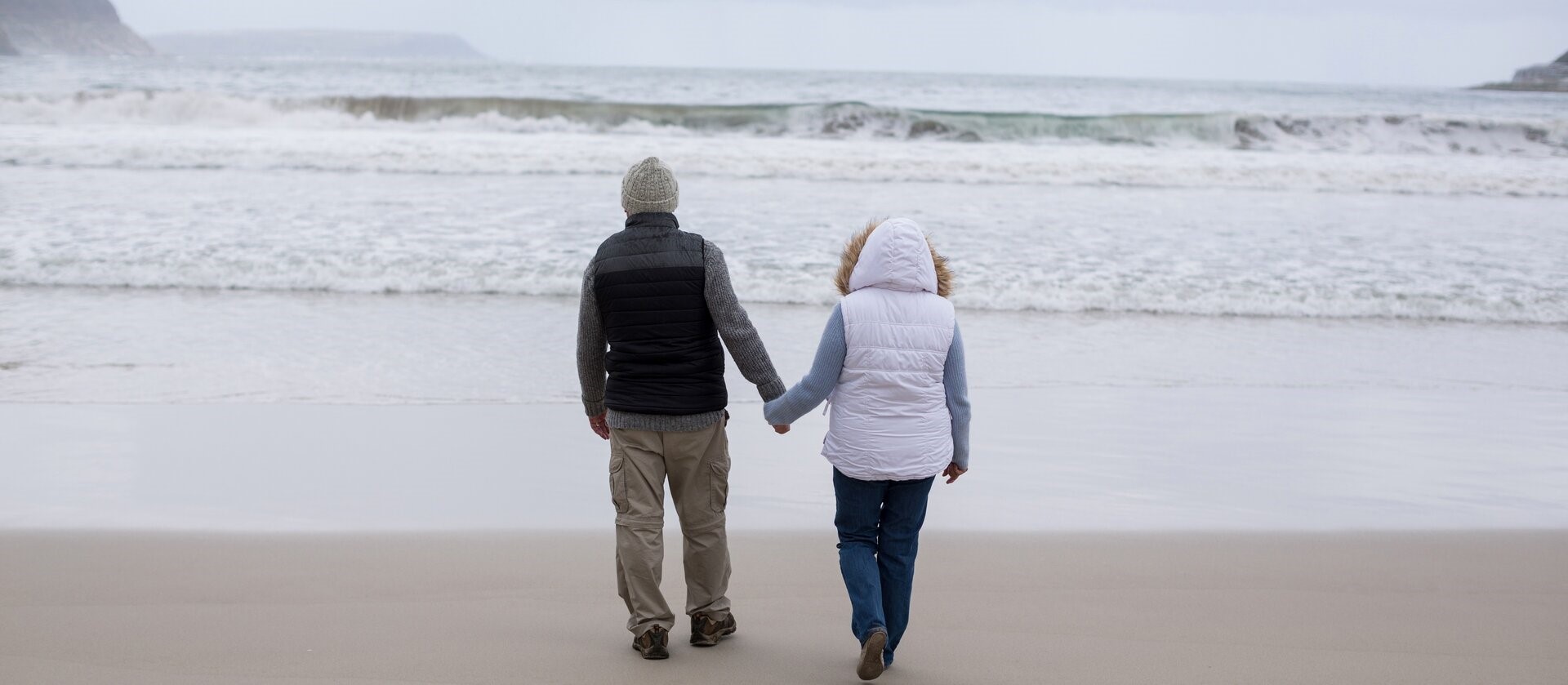 A retired couple walking the beach near Florence, Oregon