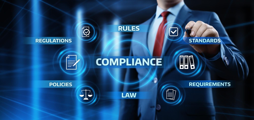 Man in a suit pointing at a glowing Compliance graphic