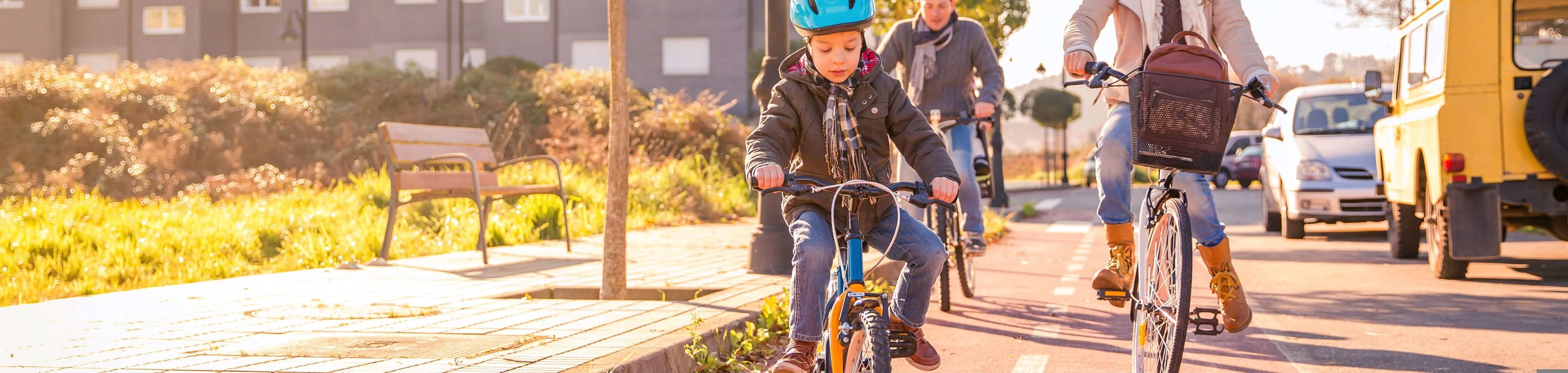 happy family with child riding bicycles in the city