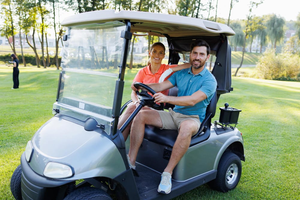 Couple smiling in a golf cart