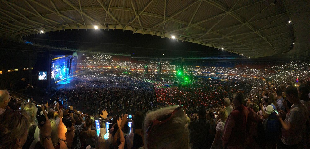 Concert crowd in a stadium with phones lit