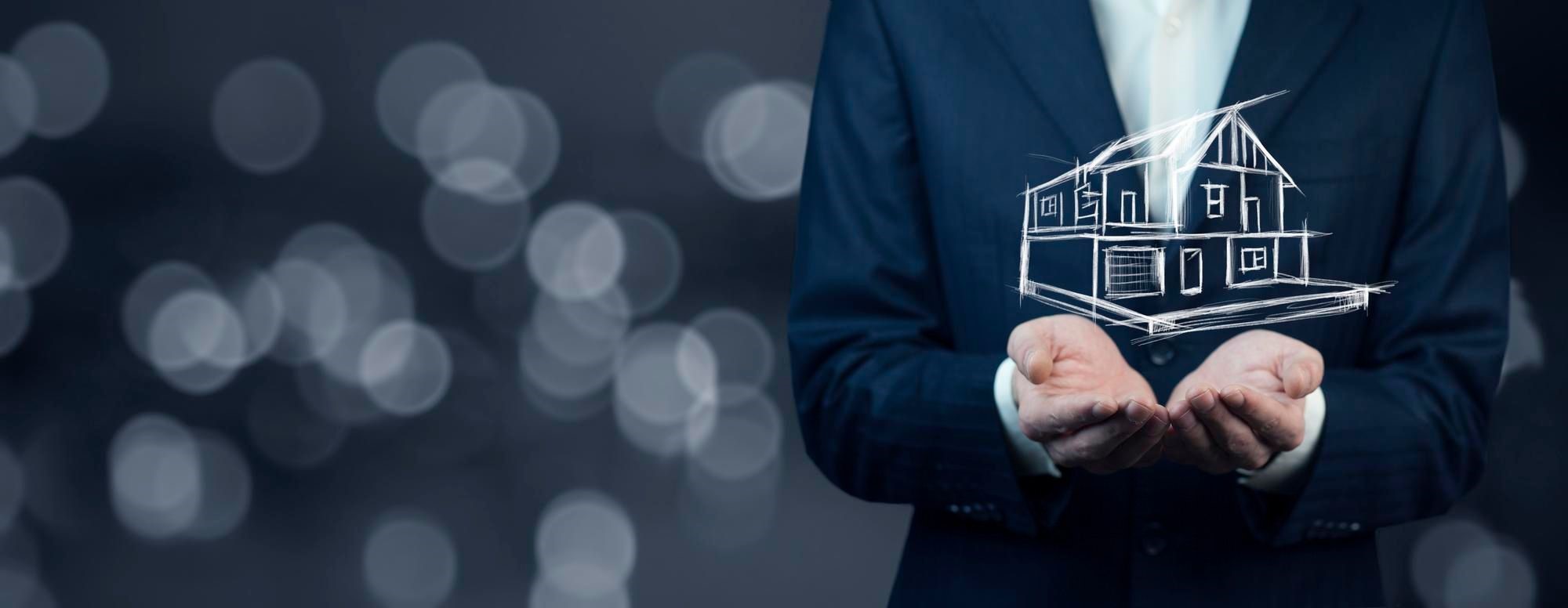 Person in a suit holding a sketched house in open palms