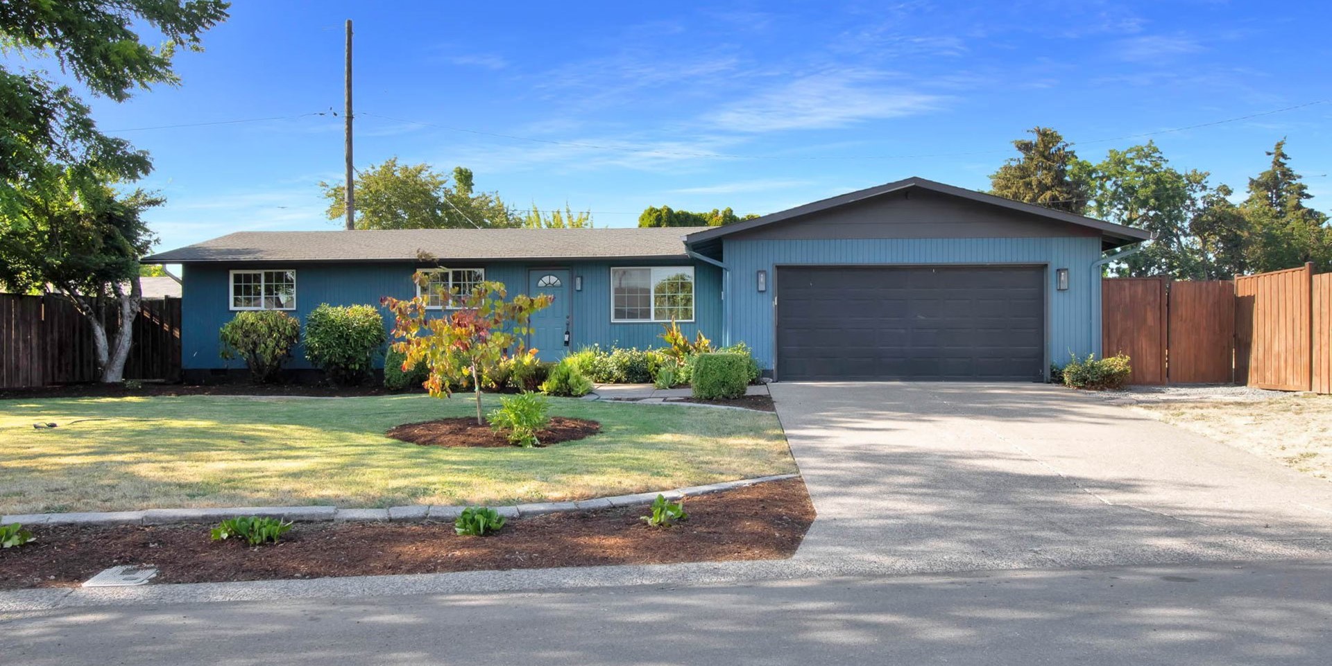 Blue single-story ranch house with an attached garage
