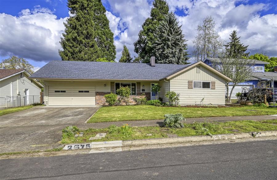 Single-story ranch home with a front porch and garage in Friendly Street Neighborhood Eugene Oregon