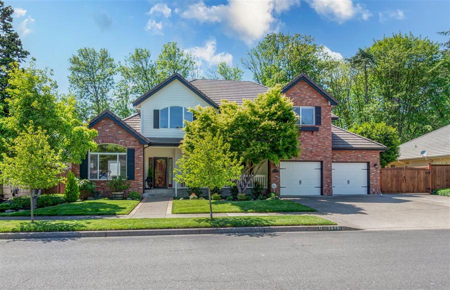 Luxury Two-story home with brick facade, dual garages, and landscaped yard in Eugene Oregon North Gilham Neighborhood