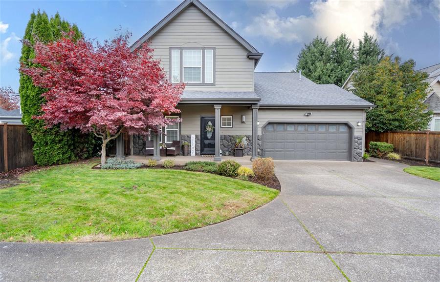 Two-story suburban home with stone accents and colorful landscaping in Santa Clara Area of Eugene