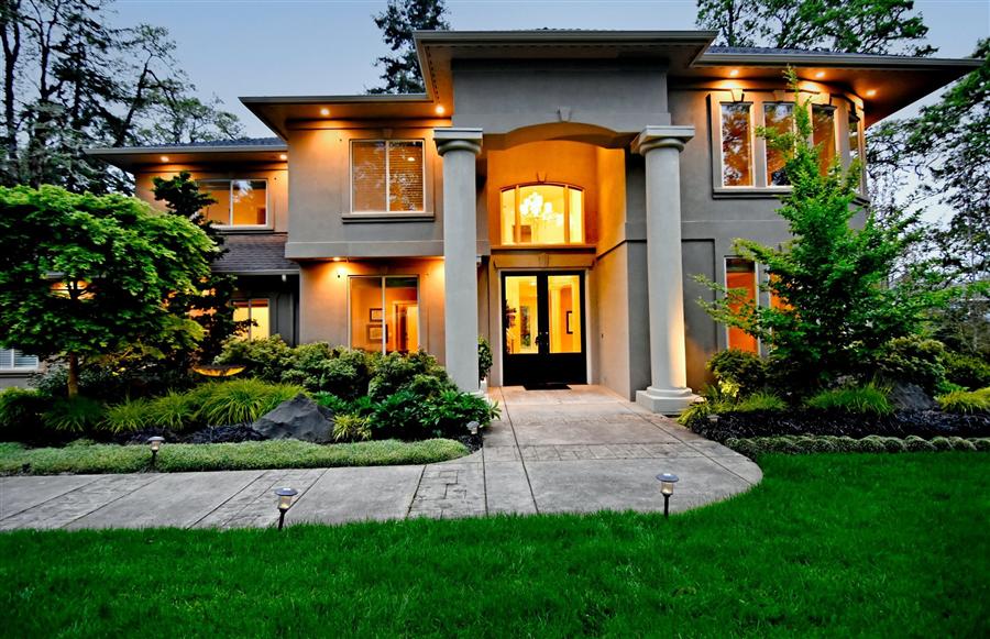 Modern two-story luxury home with large columns and landscaped front yard in Southeast Eugene Oregon