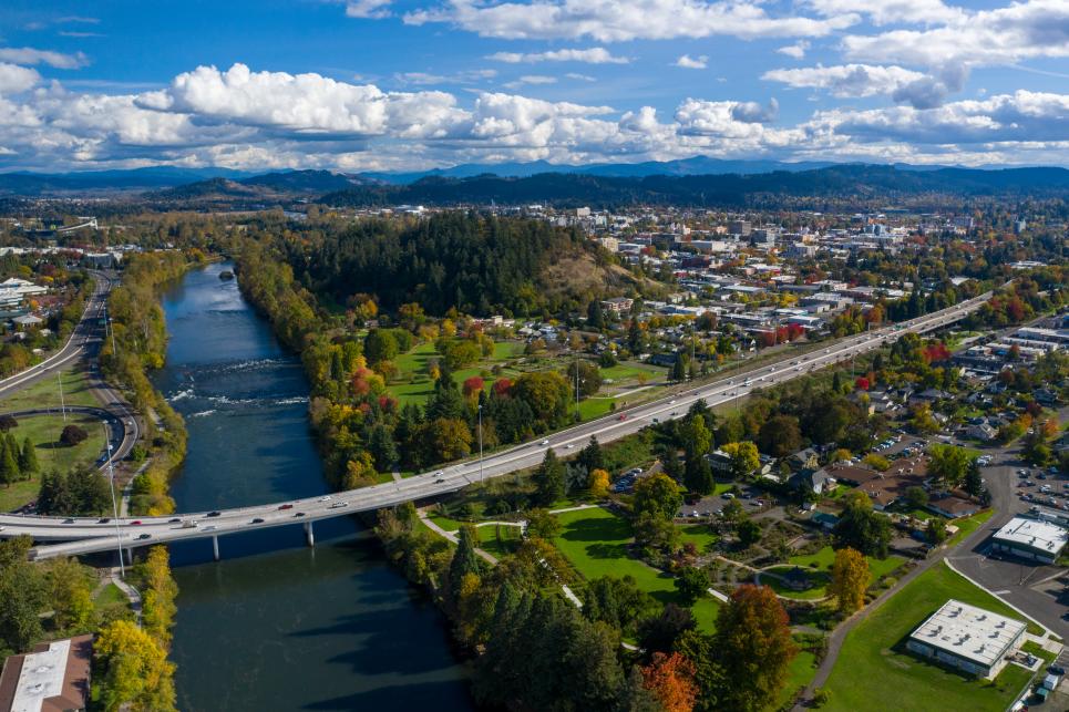 Aerial view of the Willamette River, Ferry Street Bridge, and downtown Eugene in fall